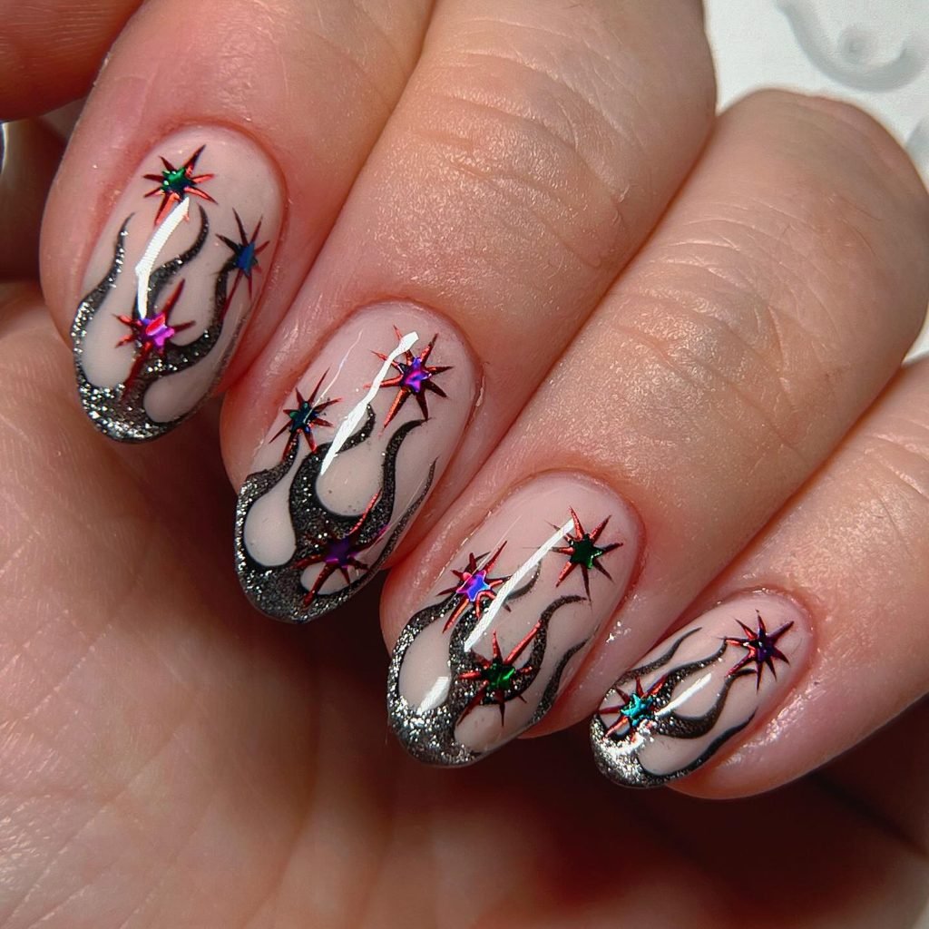 Colorful star and flame nail art design with glitter accents on manicured nails.
