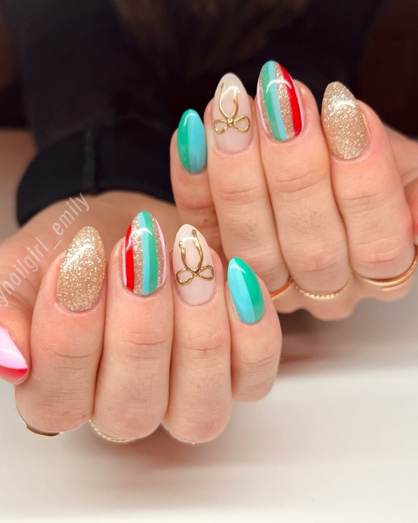 Colorful nail art featuring gold accents, glitter, and bold stripes in turquoise, red, and pink on manicured hands.
