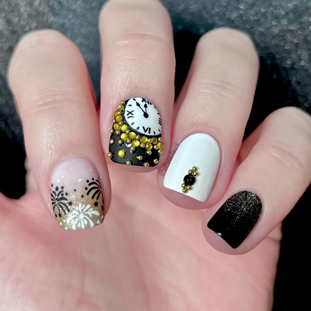 Festive New Year's Eve nail art with clock, fireworks, gold embellishments, and black and white designs.
